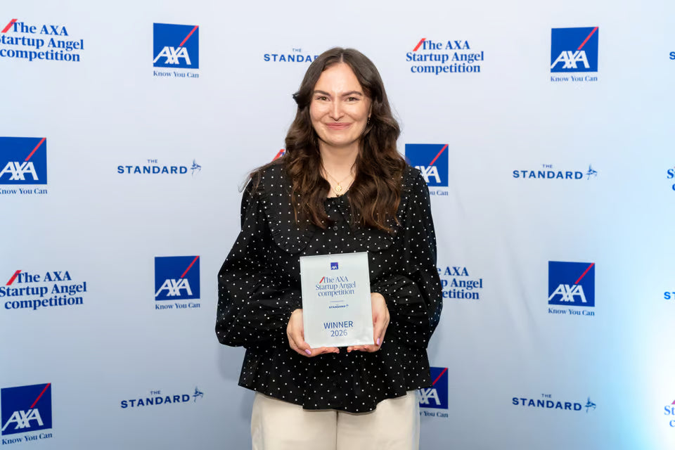 Megan Oliver, founder of SOAKED Umbrellas, holding her trophy at the AXA Startup Angel awards night