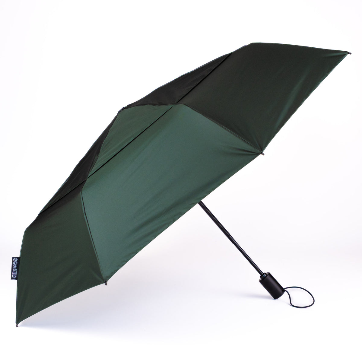 Side view of the vented, wind-resistant canopy on the SOAKED Big Sur forest green umbrella