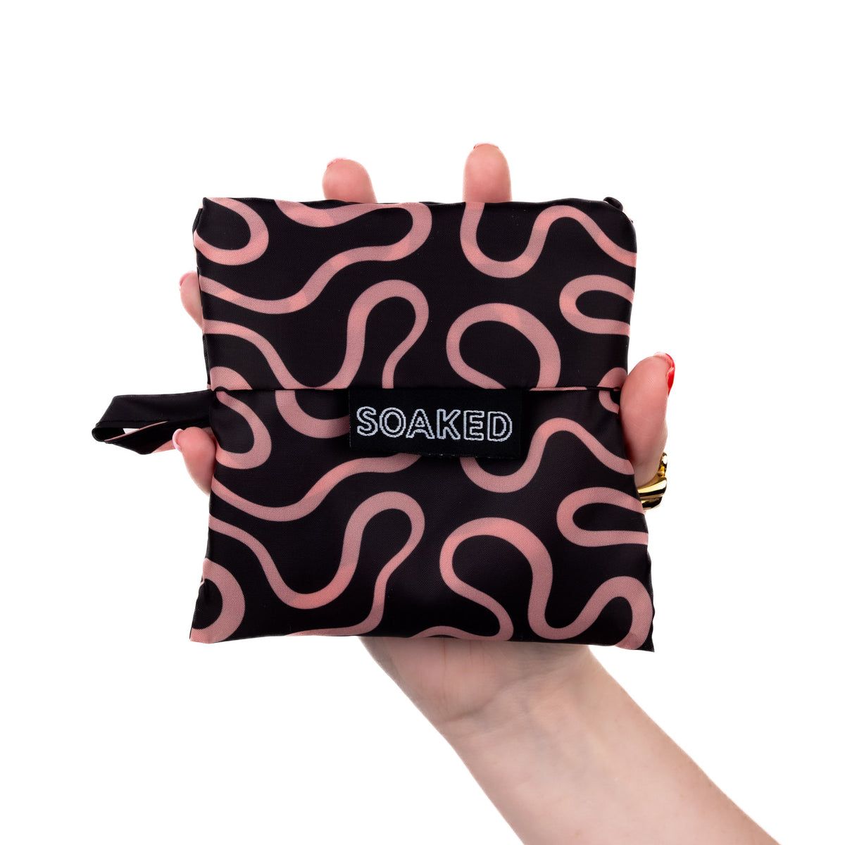 SOAKED Doodle black and peach swirl tote bag folded small and compact, made from recycled plastic