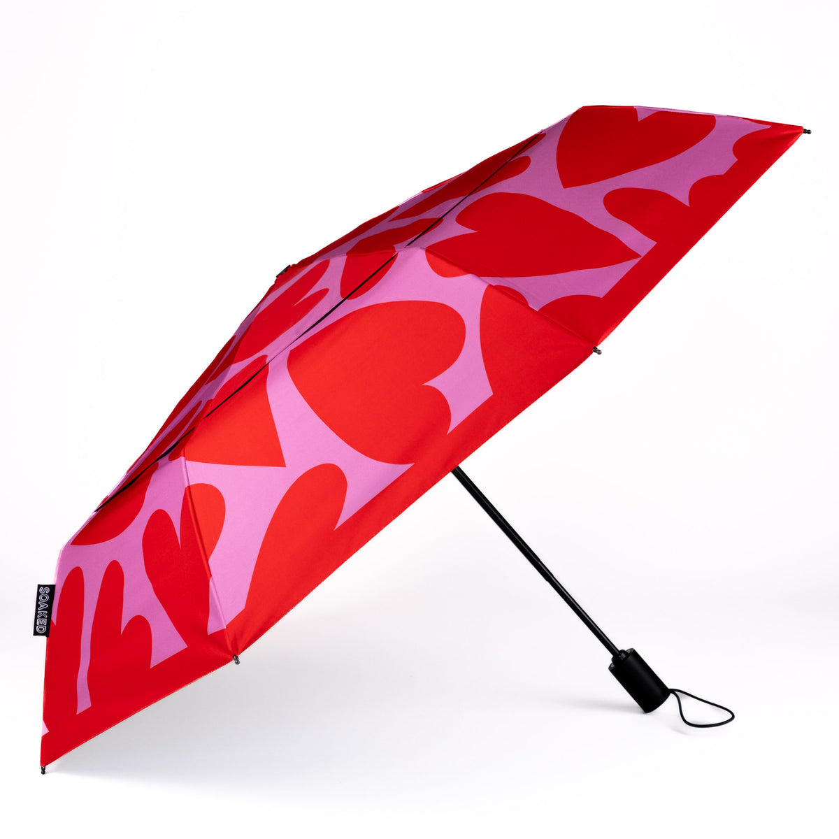 Side view of the vented, wind-resistant canopy on the SOAKED Love Bug heart print umbrella