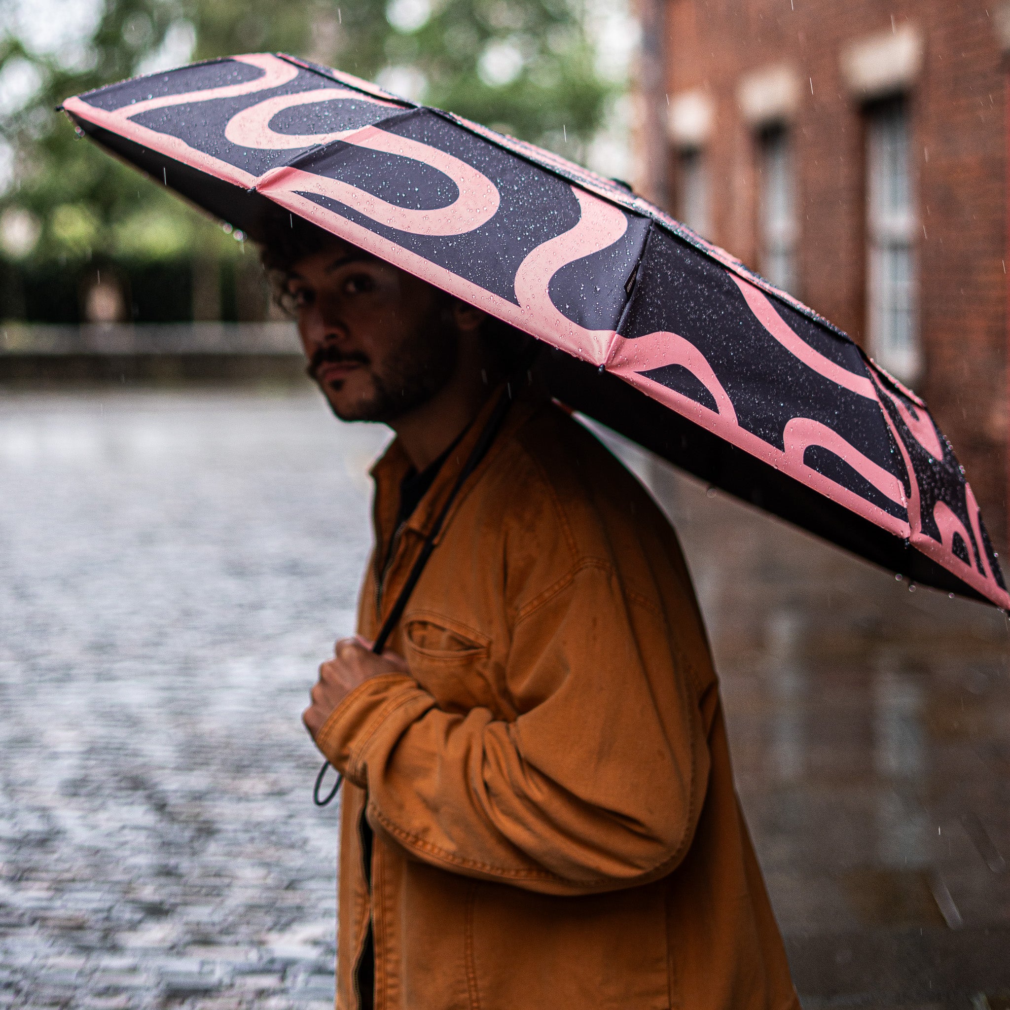 SOAKED Doodle umbrella fully open, displaying pattern scale and durable build