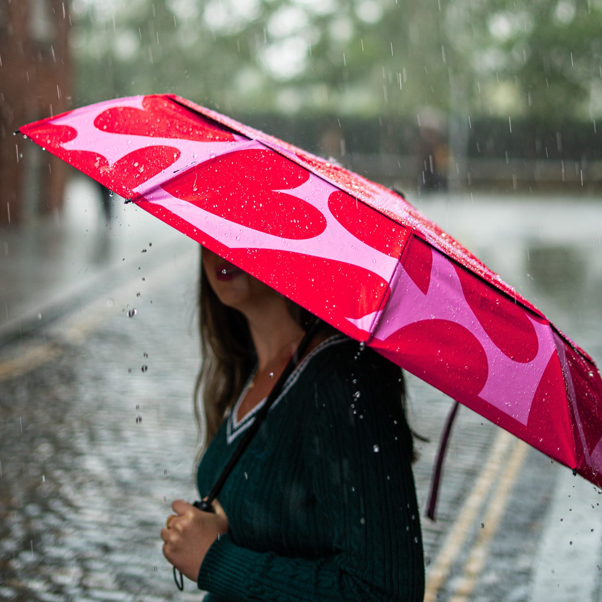 Open SOAKED LOVE BUG umbrella showing bold pattern and vented wind-resistant canopy