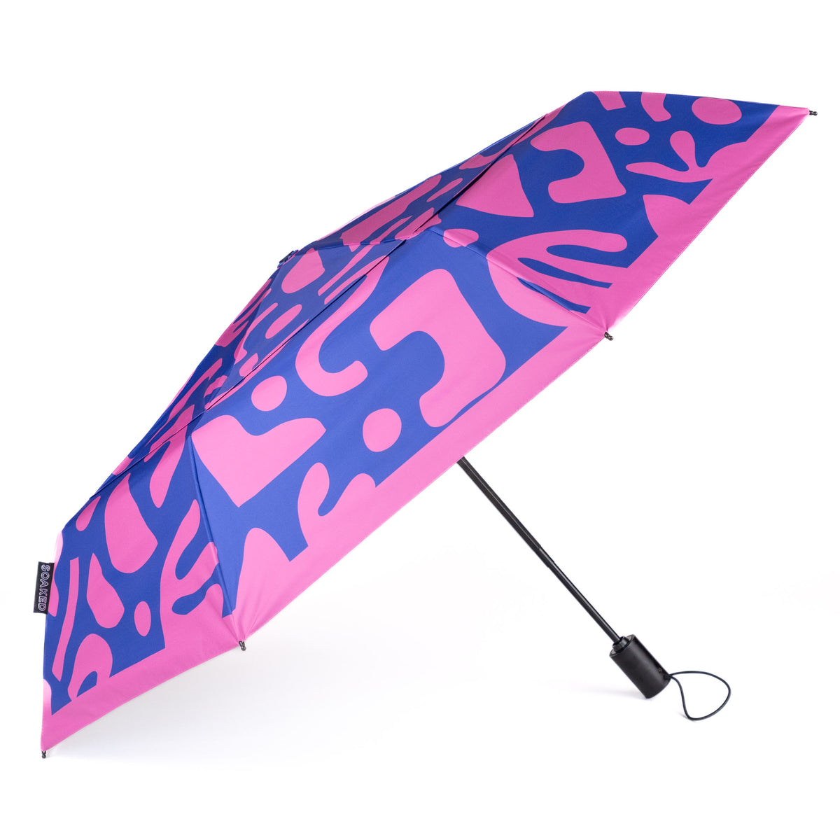 Side view of the vented, wind-resistant canopy on the SOAKED Bits and Bobs purple and blue umbrella