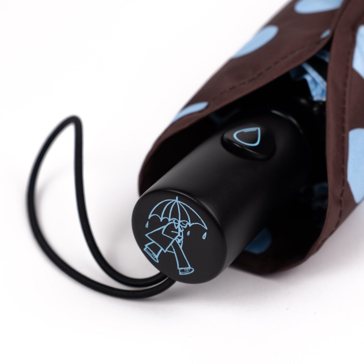 Close-up of the FSC-certified wooden handle and raindrop button on the SOAKED Polka umbrella