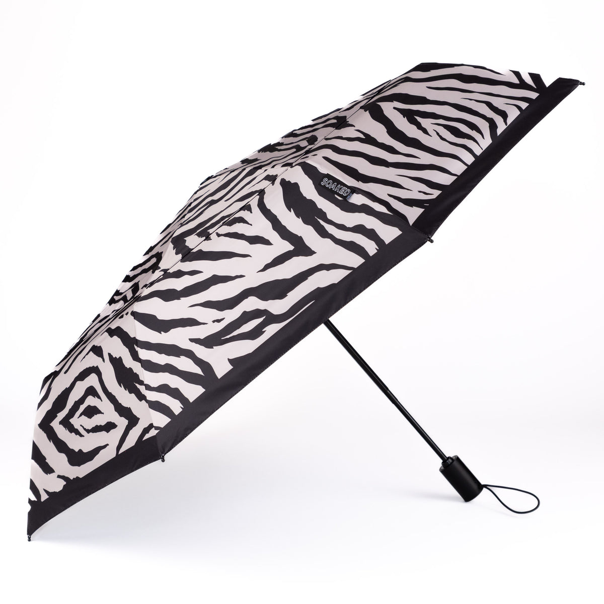 Side view of the vented, wind-resistant canopy on the SOAKED Safari zebra print umbrella