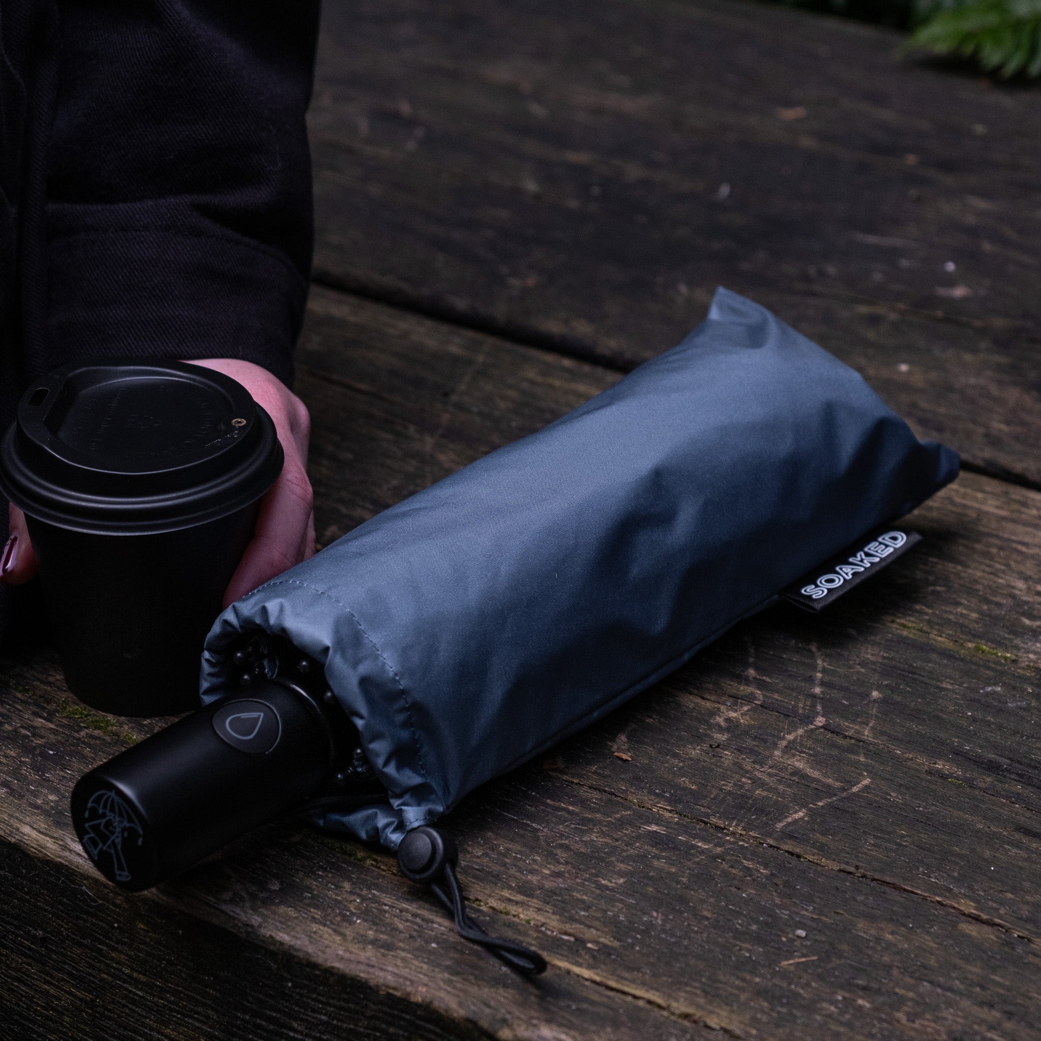 SOAKED compact umbrella folded size comparison showing generous coverage and easy portability