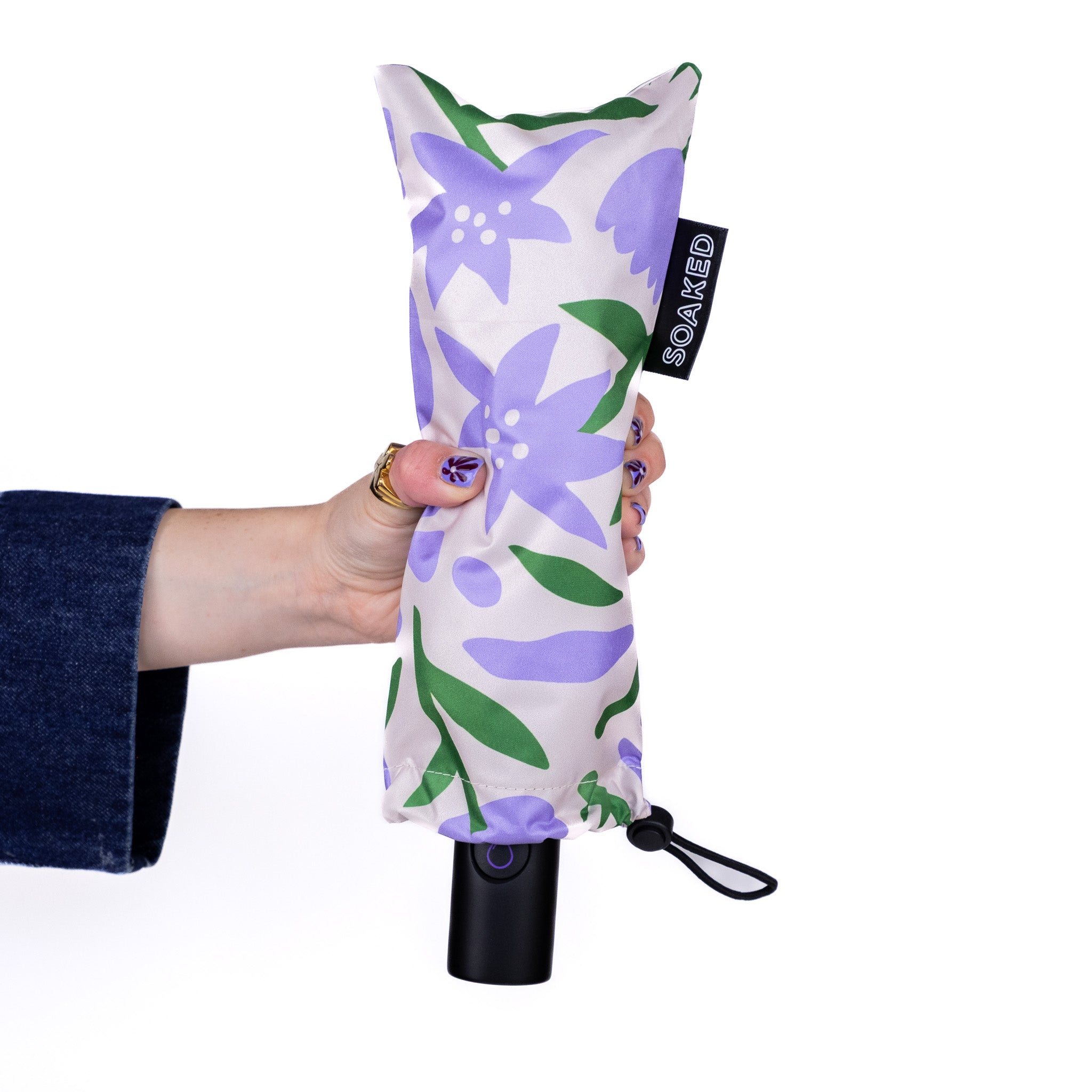 SOAKED Wildflowers umbrella in its sleeve — compact storage pouch, recycled RPET design from Manchester's sustainable umbrella brand